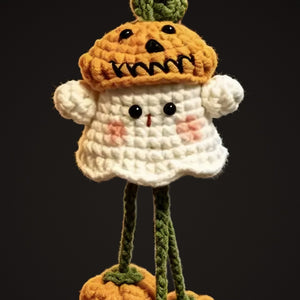 Close-up of the crochet ghost with jack-o'-lantern hat and rosy cheeks